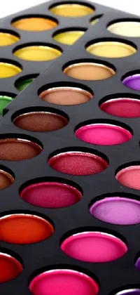 This phone live wallpaper features a colorful tray of eyeshadows, captured in high detail with 256 vibrant colors