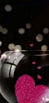 This live wallpaper for your phone showcases a stunning, close-up image of a fishbowl with a heart in it, set against a striking black background