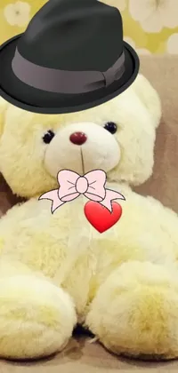 This dazzling live phone wallpaper features a white teddy bear wearing a black hat with a red bowknot