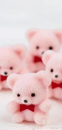 This pink live wallpaper for your phone features a group of cute teddy bears crafted from colorful felt, adorned with candy decorations
