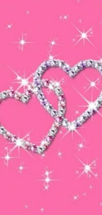 This mobile live wallpaper features two hearts on a bright pink backdrop, sparkling stars add an air of fantasy