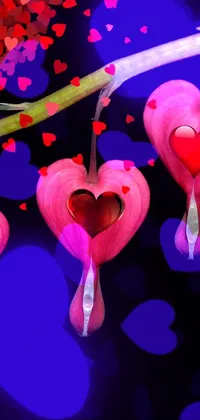 This phone live wallpaper features bleeding heart flowers arranged in a heart shape against a black background