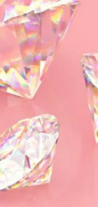 This phone live wallpaper showcases three diamonds resting on a soft pink surface