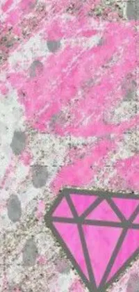 This phone live wallpaper depicts a stunning pink diamond that has been painted onto the side of a building