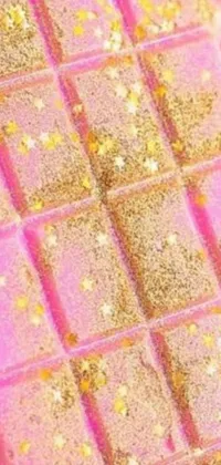 This live wallpaper showcases a stunning pink and gold chocolate bar up close, amidst a backdrop of twinkling stars, lively squirrels and a refreshing lemon cocktail