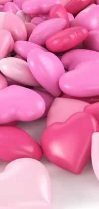 This phone live wallpaper features a stunning pile of pink and white hearts arranged on a white surface