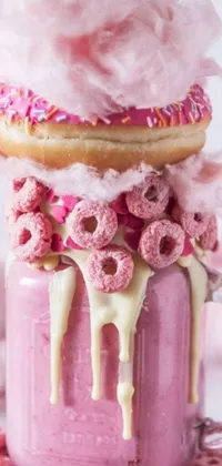 Indulge in a delicious and Instagram-worthy live wallpaper featuring a vibrant and creamy pink milkshake topped with a fruity and delectable donut