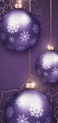 This live phone wallpaper features three stunning purple Christmas balls, each decorated with snowflakes, set against a beautiful background image