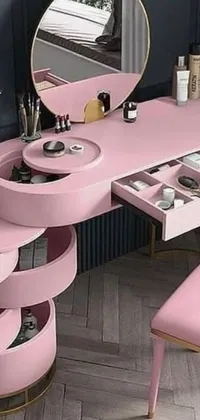 This trendy phone live wallpaper showcases a pink dressing table with a mirror, stool, and a collection of beauty accessories