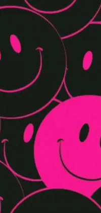 This fun and playful phone live wallpaper features a pink smiley face surrounded by black smiley faces that move around it