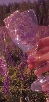 This stunning live wallpaper features a mesmerizing scene of a wine glass surrounded by a plethora of colorful flowers