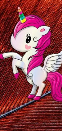 This lively and colorful phone wallpaper features a cute cartoon unicorn with red feathered wings, seen in a chibi-inspired digital painting style
