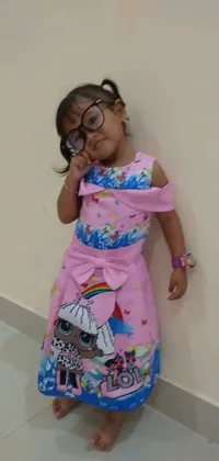 This phone live wallpaper displays an adorable little girl wearing glasses in a pink floral gown with a cheerful expression, designed with sleeveless sophistication