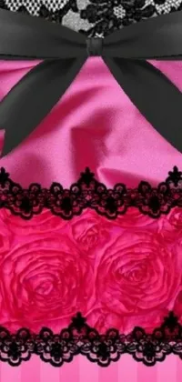 This lively phone wallpaper features a close-up of a digital-rendered pink and black dress with detailed lace patterns and ribbons inspired by laced lingerie