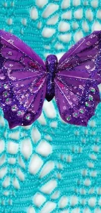 This live phone wallpaper features a digital rendering of a purple butterfly perched on a blue doily