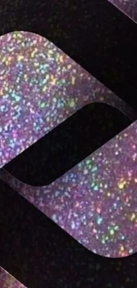 This phone live wallpaper displays a technical device on a table, featuring a holographic design with purple sparkles and dark rainbow colors