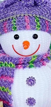 This snowman phone live wallpaper is sure to brighten up your mobile device with its colorful iridescent accent and intricate crochet details