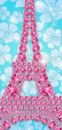 This unique phone live wallpaper features a stunning pink diamond Eiffel Tower atop a blue background with whimsical flower power motifs