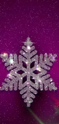 This phone live wallpaper features a close-up of a snowflake on a purple background, shimmering diamonds, and twinkling stars