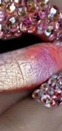 This phone live wallpaper depicts a close-up view of lips adorned with glitter and pink diamond-like patterns