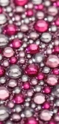 This phone live wallpaper showcases a stunning close-up view of pink bead stipple design enhanced with various gemstones and diamond for fruit-like appearance