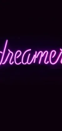 The phone live wallpaper features a vibrant neon sign that says "Dreamer" in bold letters against a retro-styled diner backdrop