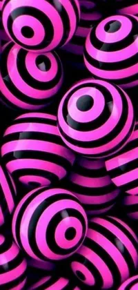 This live wallpaper features a pile of pink and black striped beads with glowing magenta laser eyes and neon circles floating around them