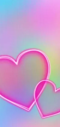This live phone wallpaper showcases two pink hearts resting beside one another against a flowing, rainbow-colored backdrop