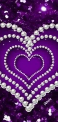 This stunning live wallpaper features a heart of pearls on a purple background