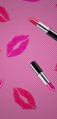 This live phone wallpaper features bold and bright lipsticks and lipstick kisses on a playful pink background