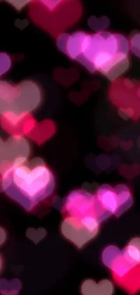 Enhance the look of your phone with this stunning live wallpaper featuring a bunch of pink and purple hearts set against a black background