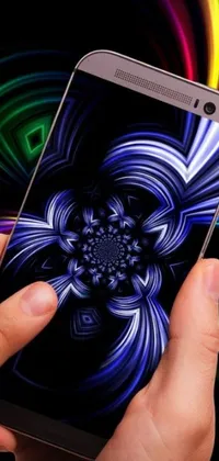 This phone live wallpaper depicts a close-up of a hand holding a cell phone with a holographic case display