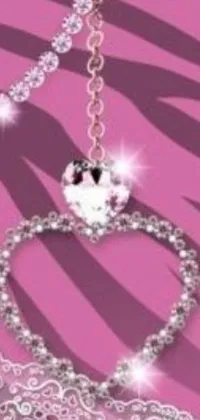 This live phone wallpaper is a stunning display of a heart-shaped necklace set against a soft pink background