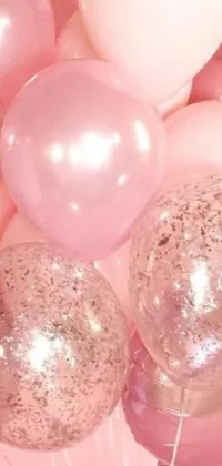 This phone live wallpaper showcases a charming scene featuring a cluster of balloons resting on a shimmering rose quartz table