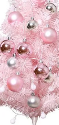 Brighten up your phone screen this holiday season with a stunning live wallpaper featuring a pink Christmas tree with silver and pink ornaments