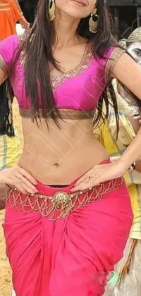 This live phone wallpaper shows a beautiful Indian woman in a pink sari posing playfully for the camera