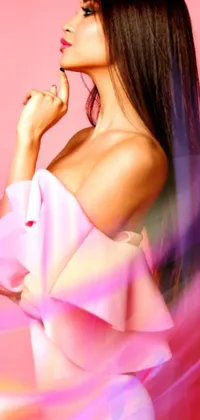 This stunning live wallpaper features a beautiful woman wearing a flowing pink gown, set against a soft, pink background