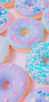 This live phone wallpaper features a table loaded with delicious doughnuts gleaming with sprinkles in pastel tumblr aesthetics