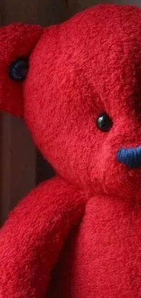 This live phone wallpaper showcases a delightful red teddy bear sitting serenely beside a window