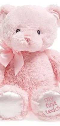 This adorable live phone wallpaper features a pink teddy bear with a bowtie on its neck against a pastel-colored background with subtle hurufiyya detailing