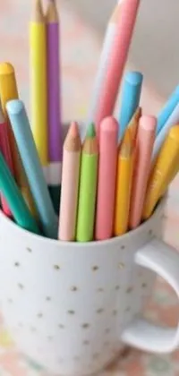 This live wallpaper boasts a cup overflowing with vibrantly colored pencils atop a table