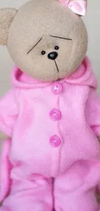 Enjoy a charming live wallpaper of a cute teddy bear wearing a pink cloak with a hood and baggy pajamas