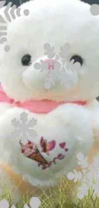 This phone live wallpaper features a charming white teddy bear surrounded by lush green grass in a love theme