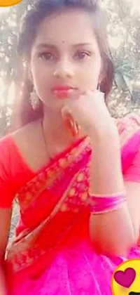 This live wallpaper showcases a young woman in a stunning pink sari, exuding confidence and elegance