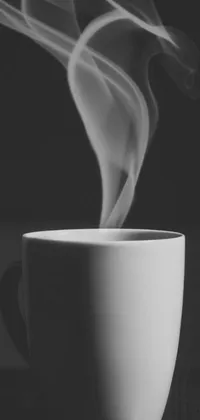 This live wallpaper features a white cup sitting on a wooden table, smoke and gas, and a black and white photo
