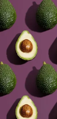 Bring some fun into your phone with this avocado-themed live wallpaper! Featuring multiple illustrations of avocados in varying shapes and tones of green set against a captivating purple background, this on-trend design is both unique and playful