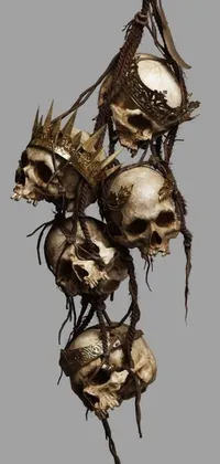 Decorate your phone's background with a dark and moody live wallpaper featuring a string of dead flowers with a skull crown and a crown of thorns