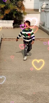This live wallpaper features a cute little boy standing in the street with pink hearts filling the background, perfect for adding a touch of sweetness to your phone's screen