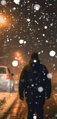 This winter night live wallpaper captures a snowstorm and an eerie, hyperrealistic scene, with a somber man walking down a snowy, suburban street