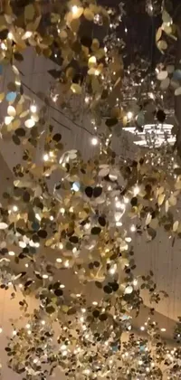 Add a touch of artistic flair to your phone screen with this mesmerizing live wallpaper! Featuring a dynamic mix of design elements, including hanging lights, glittering gold flakes, and abstract shapes, this incredible masterpiece is sure to captivate your attention